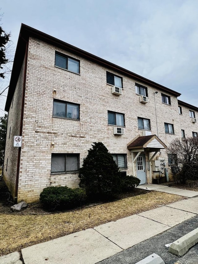 view of building exterior featuring a wall mounted AC