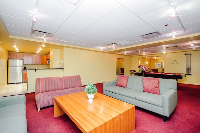 living room with rail lighting, carpet floors, and a drop ceiling