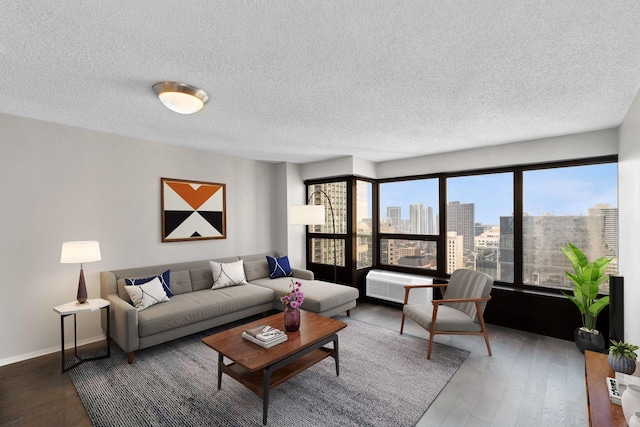 living room featuring dark hardwood / wood-style floors and a textured ceiling