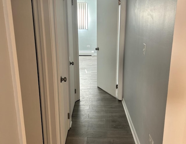 hall featuring a baseboard radiator and dark wood-type flooring