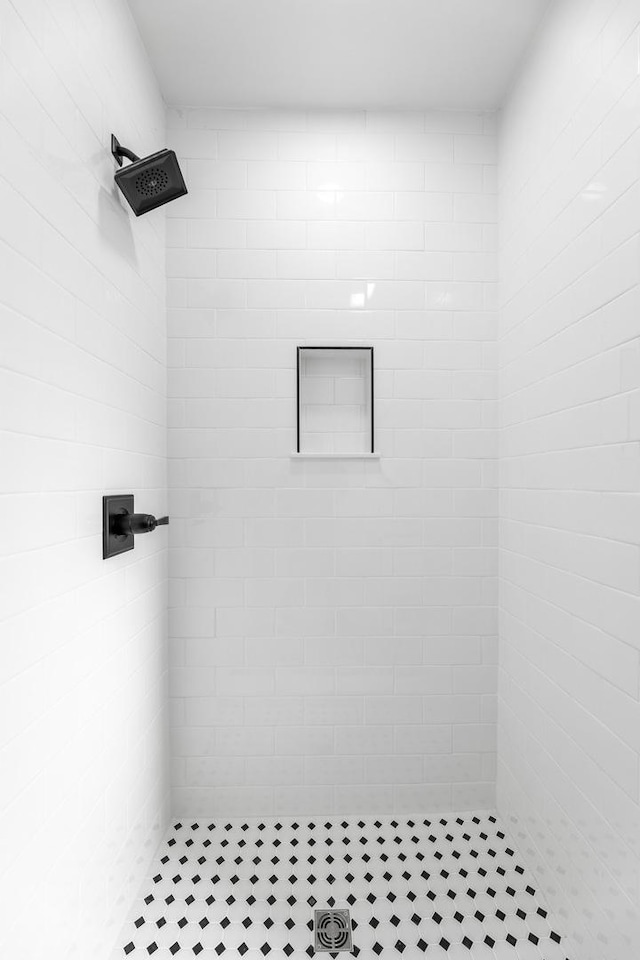 bathroom with tiled shower