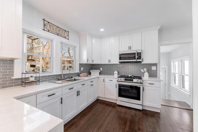 kitchen with appliances with stainless steel finishes and white cabinets