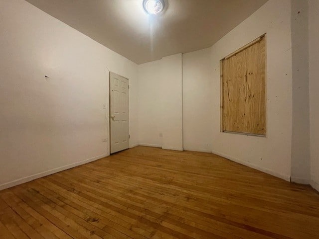 unfurnished room featuring wood-type flooring