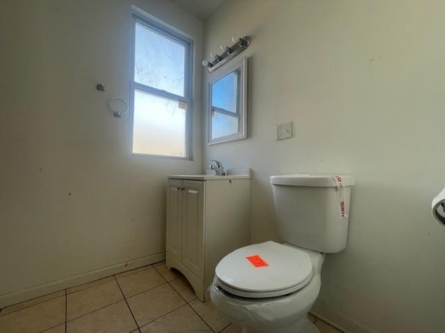 bathroom with tile patterned flooring, vanity, and toilet