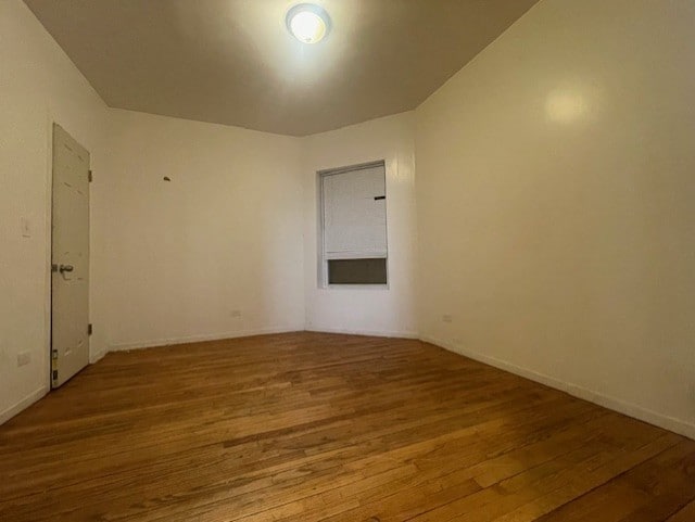 empty room with hardwood / wood-style floors