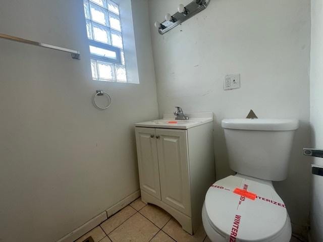 bathroom featuring tile patterned flooring, vanity, and toilet