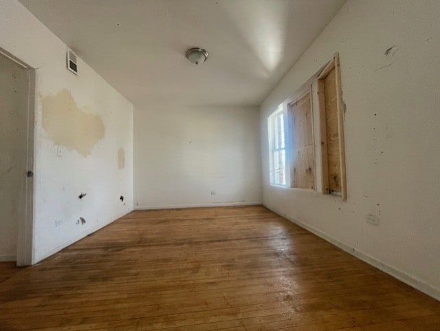 unfurnished room featuring hardwood / wood-style flooring