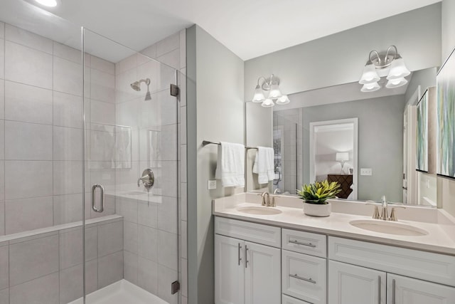 bathroom featuring vanity and a shower with door