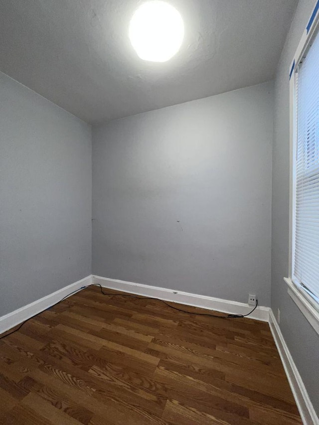 spare room with dark hardwood / wood-style flooring