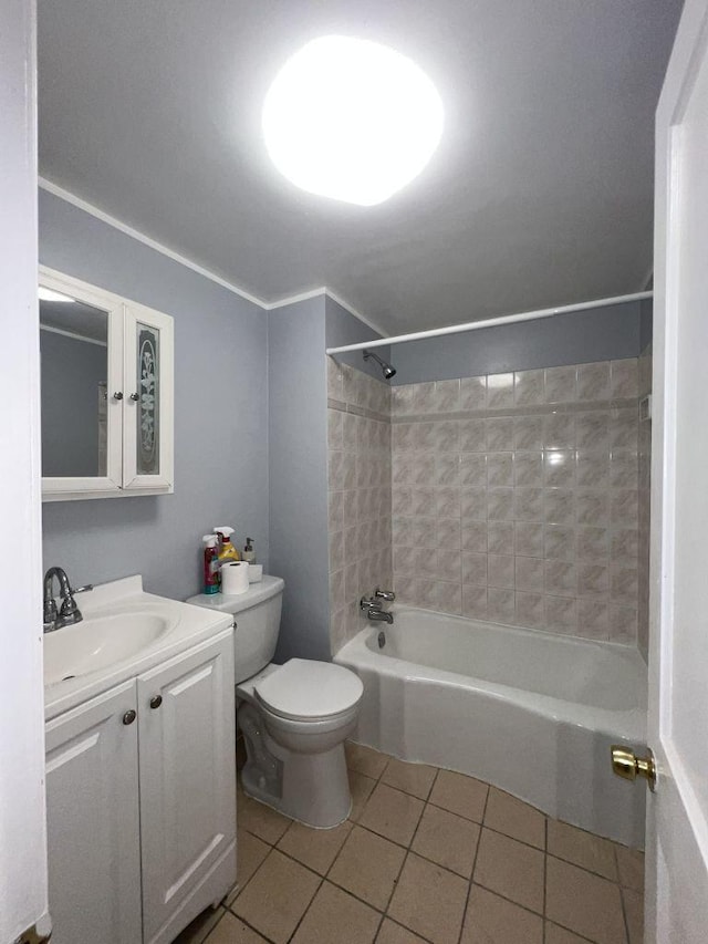 full bathroom featuring tiled shower / bath combo, vanity, tile patterned floors, and toilet