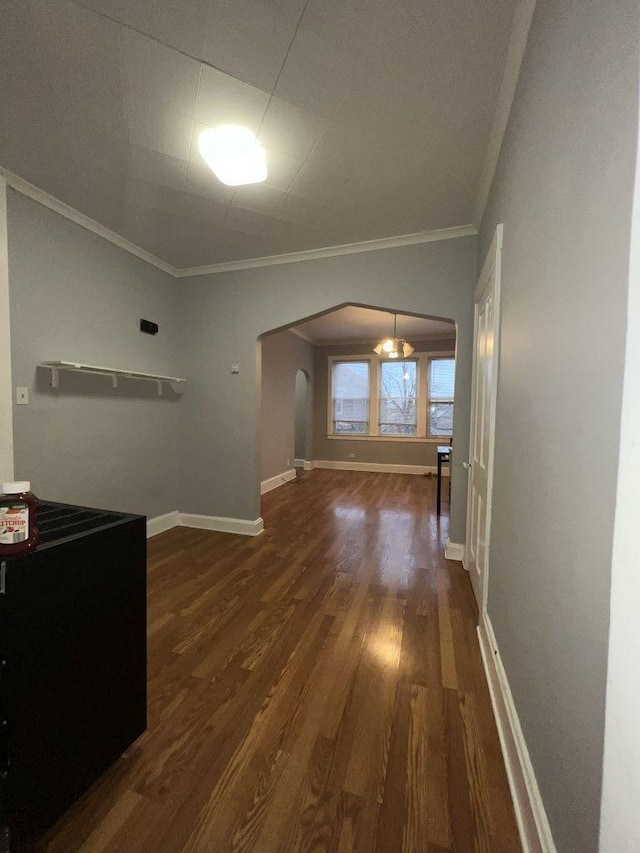 interior space featuring crown molding and dark wood-type flooring