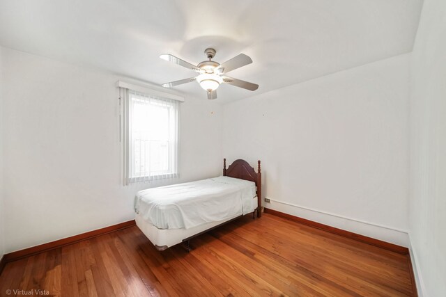 unfurnished bedroom featuring hardwood / wood-style floors and ceiling fan