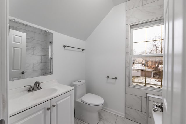 bathroom with vanity, toilet, and vaulted ceiling