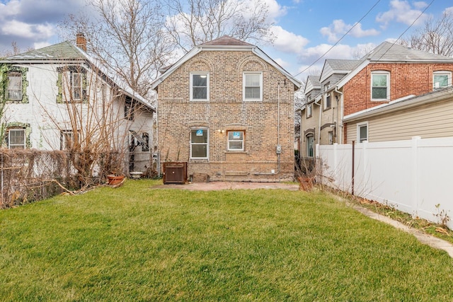 rear view of property featuring a yard and central AC unit