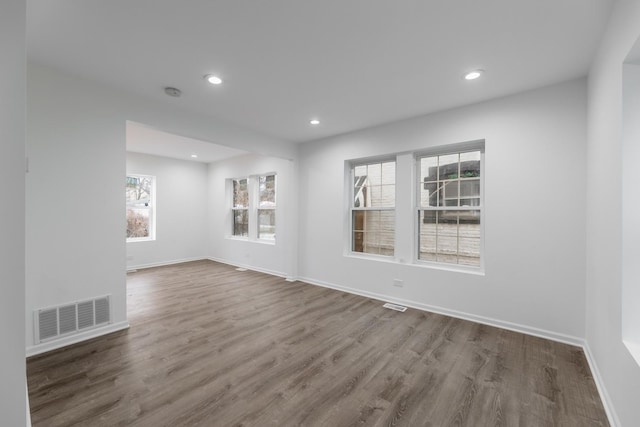 unfurnished room with hardwood / wood-style floors