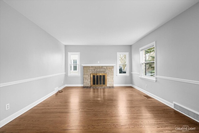 unfurnished living room featuring dark hardwood / wood-style floors and a fireplace