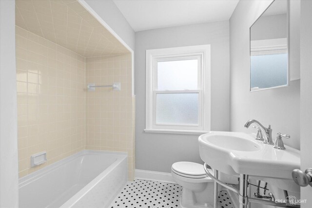 basement with sink, wood-type flooring, and plenty of natural light