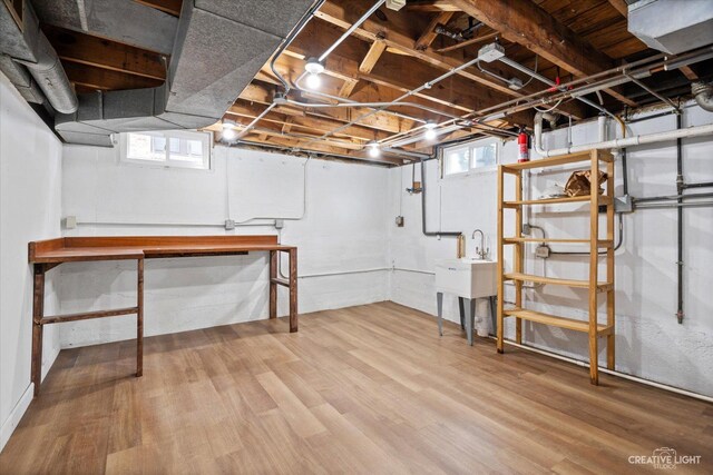 basement featuring a brick fireplace and wooden walls