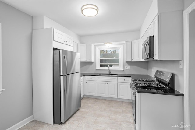 kitchen featuring white cabinetry, sink, and appliances with stainless steel finishes