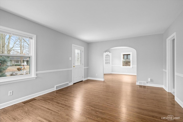 spare room featuring wood-type flooring