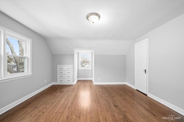 bonus room featuring lofted ceiling and dark wood-type flooring