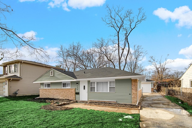 view of front of property featuring driveway, brick siding, a garage, and a front yard