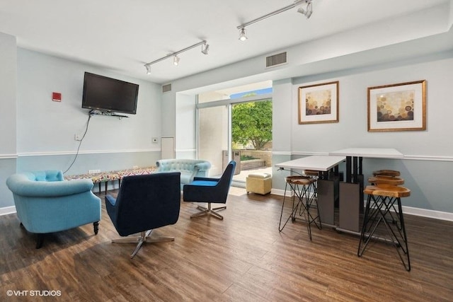 interior space featuring dark hardwood / wood-style flooring and rail lighting