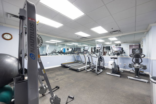 gym featuring a paneled ceiling