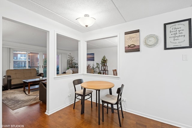 dining space with wood-type flooring