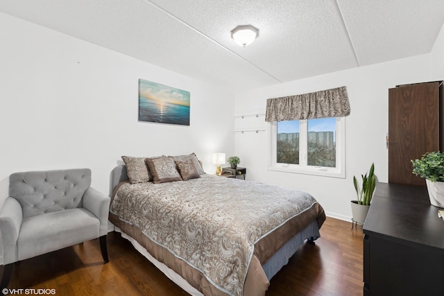 bedroom featuring dark hardwood / wood-style floors and a textured ceiling