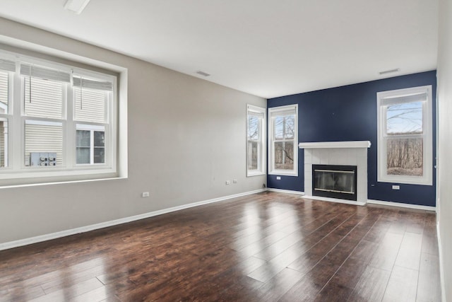 unfurnished living room with dark hardwood / wood-style floors and a fireplace