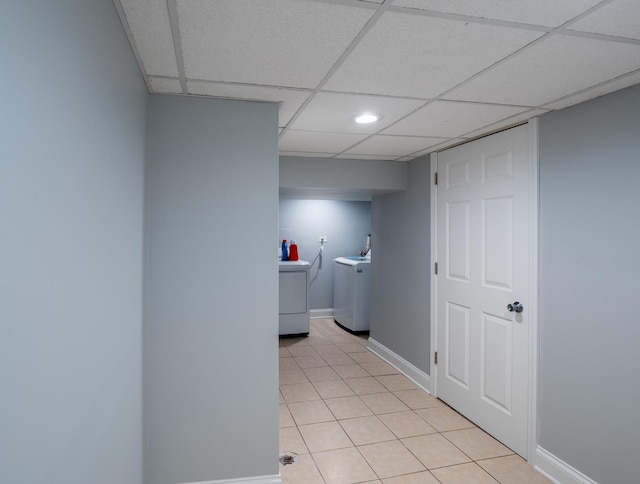 laundry room with independent washer and dryer and light tile patterned floors