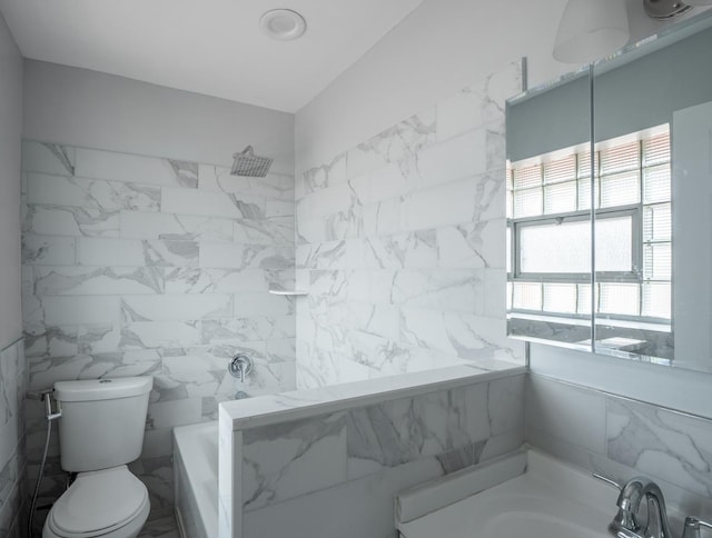 bathroom with tile walls, sink, a tub, and toilet