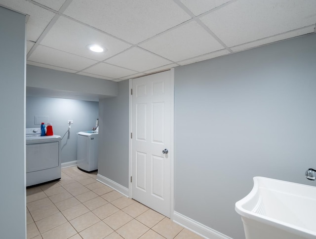 laundry room with washer / clothes dryer, light tile patterned flooring, and sink