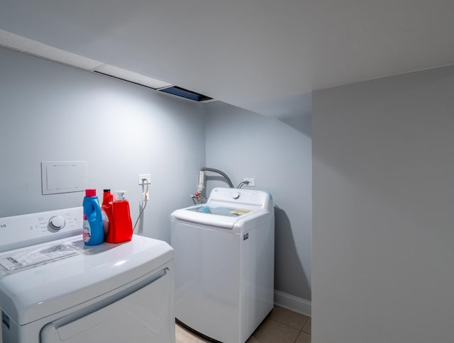 clothes washing area with separate washer and dryer and light tile patterned floors