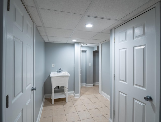 bathroom featuring tile patterned flooring and a drop ceiling