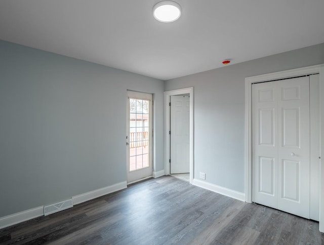 unfurnished bedroom featuring dark wood-type flooring