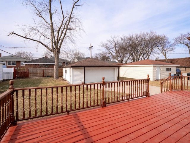 deck with a garage, an outdoor structure, and a yard