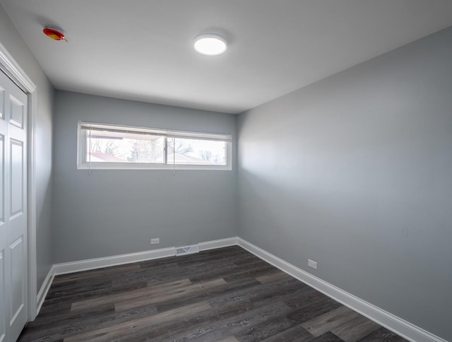 empty room featuring dark hardwood / wood-style flooring