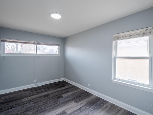 spare room with dark hardwood / wood-style flooring