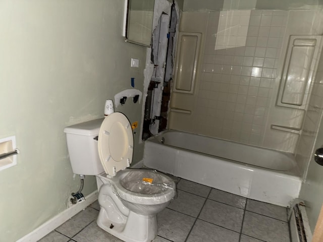 bathroom with bathtub / shower combination, toilet, and tile patterned flooring