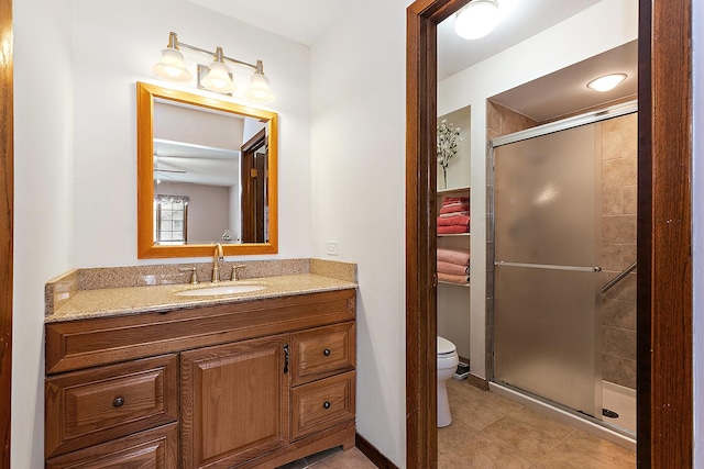 bathroom featuring vanity, toilet, tile patterned flooring, and a shower with door