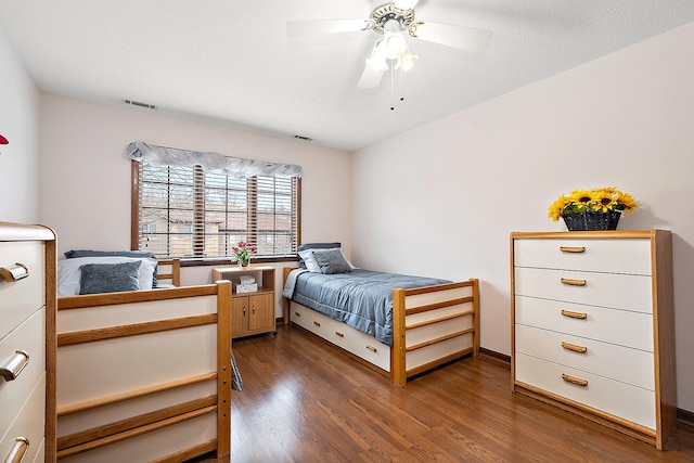 bedroom featuring ceiling fan and dark hardwood / wood-style flooring