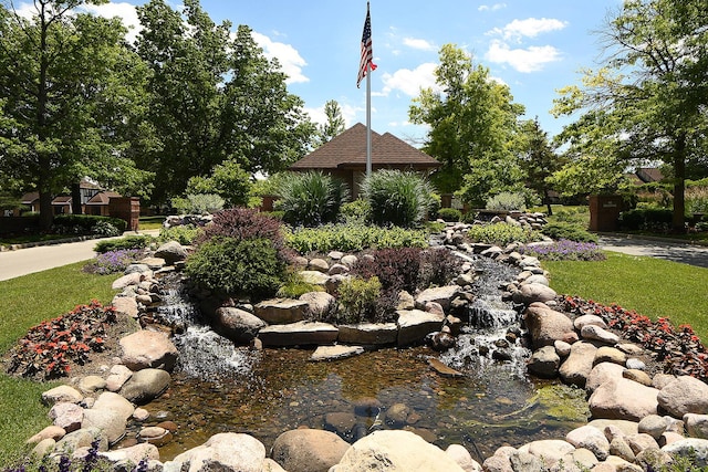 view of yard featuring a small pond