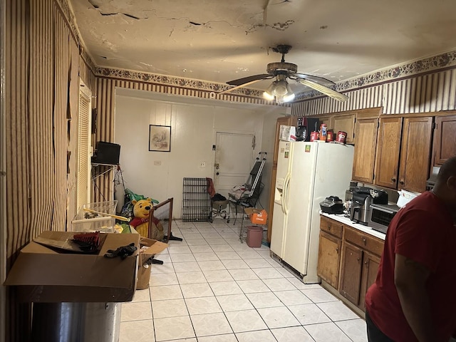 kitchen with light tile patterned floors, white refrigerator with ice dispenser, and ceiling fan