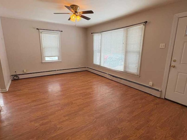 spare room featuring plenty of natural light, light hardwood / wood-style floors, and ceiling fan