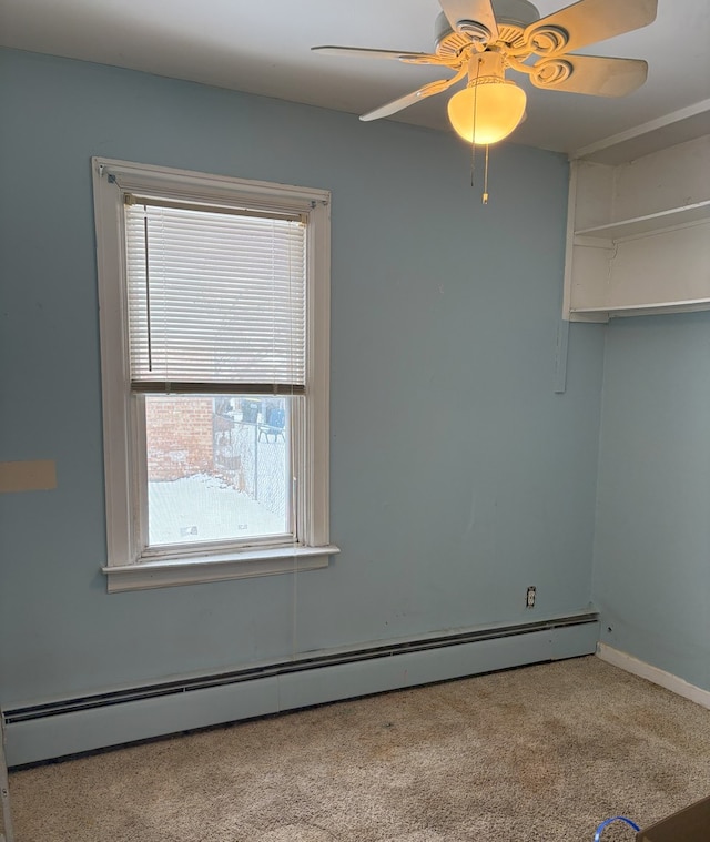 empty room with ceiling fan, light carpet, and baseboard heating