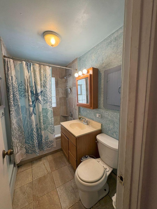 full bathroom featuring vanity, shower / bath combination with curtain, and toilet