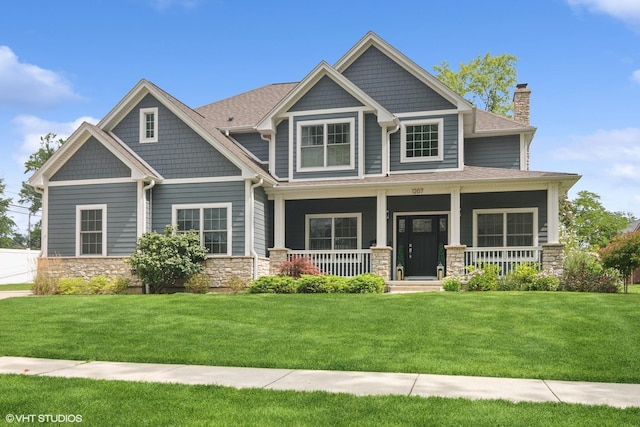 craftsman-style house with covered porch and a front lawn