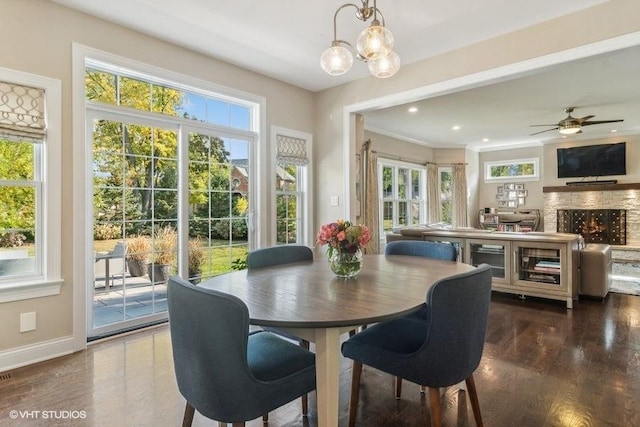 dining area featuring ceiling fan with notable chandelier and dark hardwood / wood-style floors